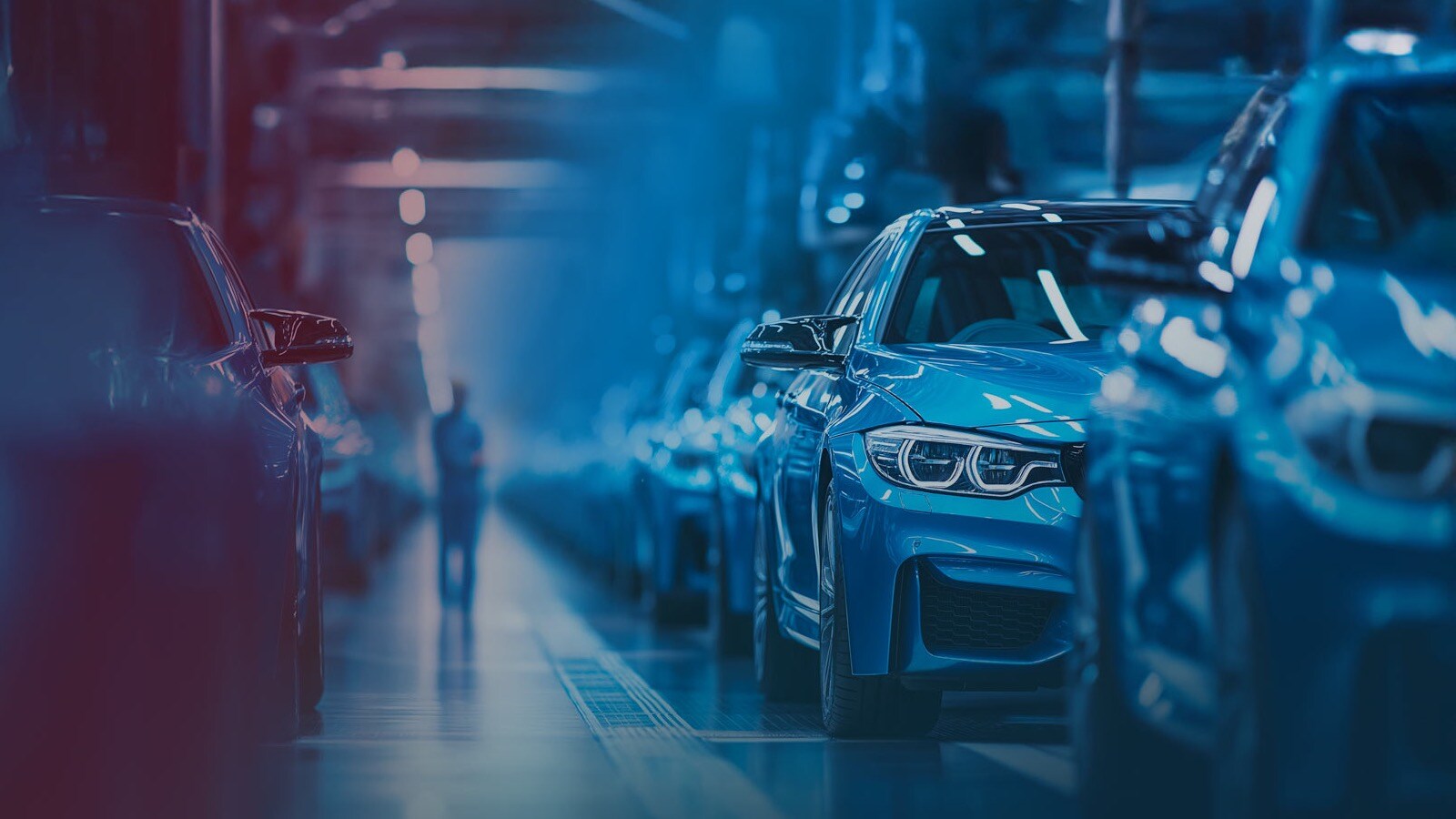 Cars on assembly line in factory