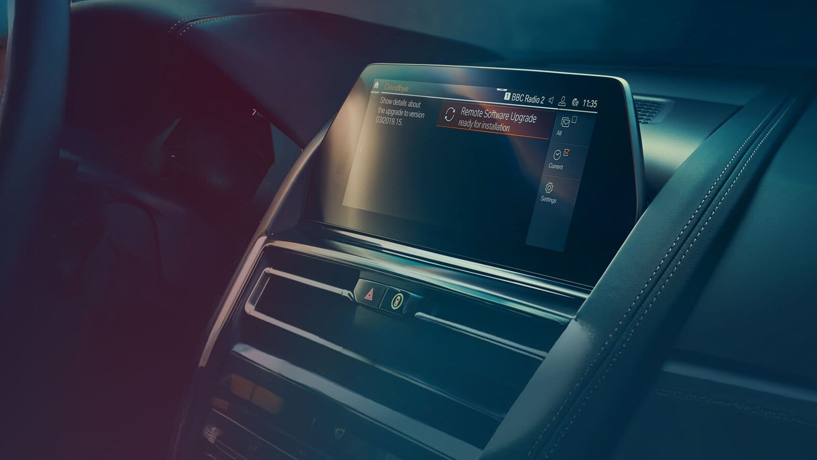 The dashboard of a car shows a display with a notification about a remote software upgrade.
