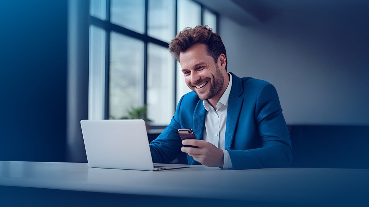 A person in a modern office checks proof of identity on the web on a laptop and smartphone.