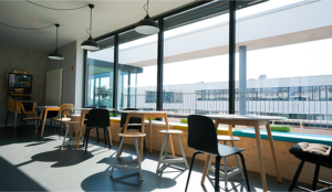 Our cozy sitting area directly on the window front, which leads to our terrace. There is a long bench as a window sill and several tables with more chairs.