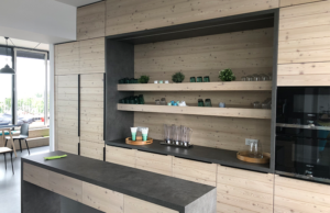 Our open kitchen in wood design with two microwaves and a long kitchen island in the middle.